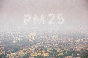 Fog or haze combined with smoke and other atmospheric pollutants in the city from PM 2.5 dust. Cityscape with word of PM 2.5 and air pollution. PM 2.5 concept. photo