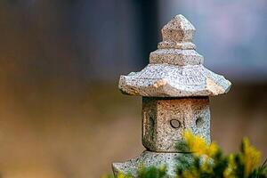 Japanese lantern covered in moss photo