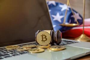 national flag of liberia on the keyboard with bitcoin coins on a grey background.concept photo
