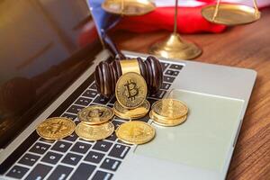 national flag of liberia on the keyboard with bitcoin coins on a grey background.concept photo