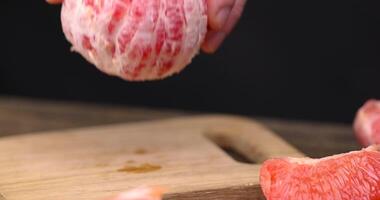 Ripe red grapefruit on a black table photo