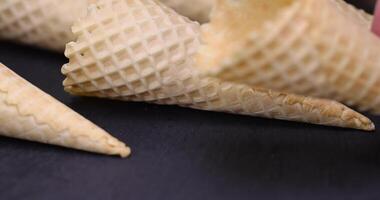 empty waffle cones for ice cream on a black slate photo