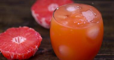 Ripe red grapefruit on a black table photo