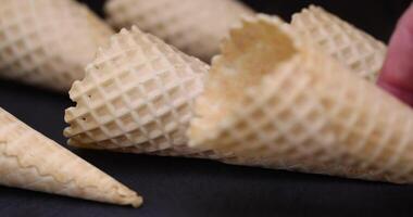 empty waffle cones for ice cream on a black slate photo