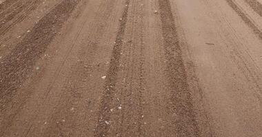 close-up of a part of a wet road without asphalt photo