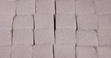 lump sugar in the shape of a square on a black slate photo