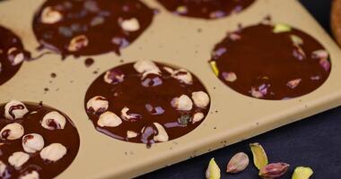 making homemade chocolate with cocoa butter and nuts photo