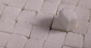 lump sugar in the shape of a square on a black slate photo