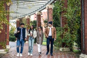 group of four university friends returning from class photo