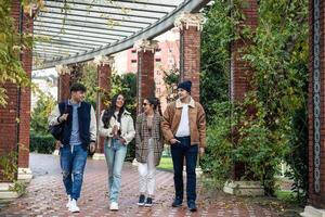 group of four student friends returning from university photo