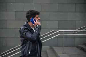 close-up young man talking on cell phone on stairs photo