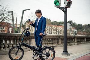 Urban Commuter businessman Multitasking with Electric Folding Bike and Smartphone copyspace photo