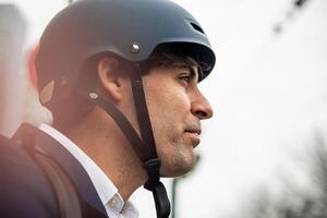 closeup of Businessman face in Suit with Bicycle Helmet photo