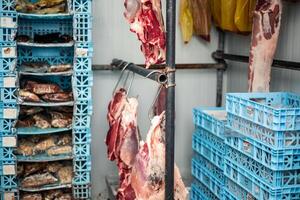 Refrigerated Cold Storage with Boxes of Meat and Beef Hanging on Hooks photo