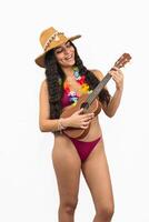 vertical portrait Latin girl in bikini and beach hat playing the ukulele on white background photo