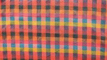 A colorful checkered fabric with a red and yellow square photo