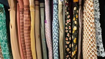A row of clothes with different patterns and colors photo