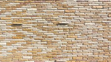 A wall made of bricks with a pattern of brown and white photo
