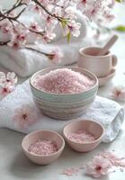 Relaxing spa setting with pink bath salts and blooming flowers in a serene environment photo