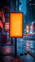 Bright billboard stands alone in a vibrant city at night with glowing lights and colorful buildings photo