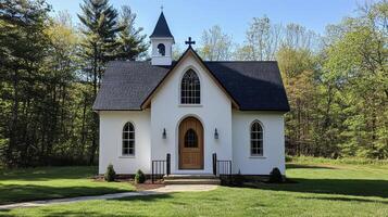 Beautiful white church surrounded by lush greenery on a sunny day photo