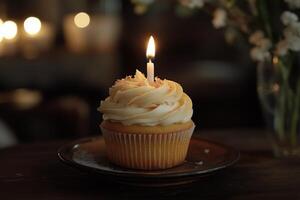 Delightful cupcake with a glowing candle and festive sprinkles for special occasions photo