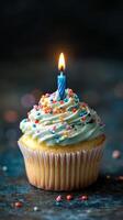 Celebratory cupcake with candle and colorful sprinkles for a special occasion photo