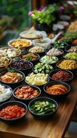 Colorful assortment of fresh salads and toppings arranged on wooden table photo