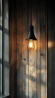 Rustic light fixture casts warm glow against wooden wall in cozy indoor setting photo