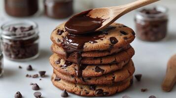 Delicious chocolate chip cookies with melted chocolate drizzle on top and chocolate chips around photo