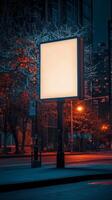 Bright billboard stands alone in a vibrant city at night with glowing lights and colorful buildings photo