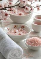 Relaxing spa setting with pink bath salts and blooming flowers in a serene environment photo