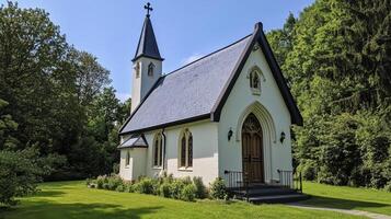 Beautiful white church surrounded by lush greenery on a sunny day photo