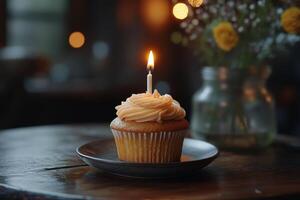 Delightful cupcake with a glowing candle and festive sprinkles for special occasions photo