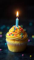 Delicious cupcake with candle glowing, perfect for celebrations or birthdays photo