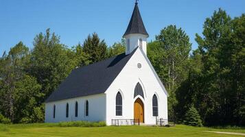 Beautiful white church surrounded by lush greenery on a sunny day photo