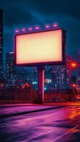 Bright billboard stands alone in a vibrant city at night with glowing lights and colorful buildings photo