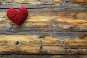 Red knitted heart on rustic wooden background evokes feelings of love and warmth photo