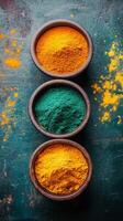 Vibrant powdered pigments arranged in bowls on a green marble surface photo