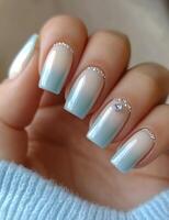 Elegant ombre manicure with sparkling accents on well-groomed nails photo