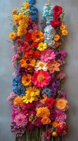 Colorful floral arrangement on a textured wall showcasing various blooms in bright shades photo