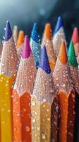 Colorful pencils with water droplets creating an artistic effect on a dark background photo
