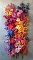 Colorful floral arrangement on a textured wall showcasing various blooms in bright shades photo