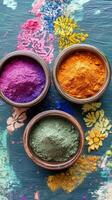 Vibrant powdered pigments arranged in bowls on a green marble surface photo