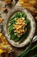 Green beans topped with almond slices on a textured platter surrounded by decorative elements photo