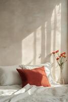 Soft sunlight casts shadows on a cozy bed with decorative pillows and floral accents in a serene room photo