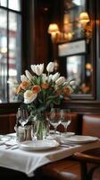 Elegant table setting with fresh flowers in a cozy restaurant during dinner time photo