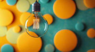 Unique light bulb hangs against a colorful, abstract background filled with bright dots photo