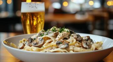 Delicious creamy mushroom pasta served with a refreshing cold beer in a cozy dining setting photo