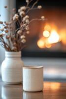 Cozy warm drink beside a glowing fireplace with dried flowers in soft background photo